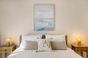 a bedroom with a bed with pillows and a painting at Villa Mila with private pool by Olivestone Village in Ágios Márkos +46 photos