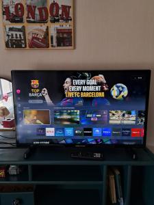 a flat screen tv sitting on top of a table at Petite Chambre CHEZ MARINA in Chantepie