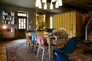 a dining room with a wooden table and chairs at GRAACE House Suites in Luxembourg