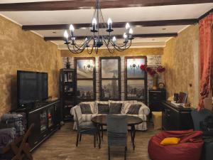a dining room with a table and a chandelier at Chillout-House in Mińsk Mazowiecki