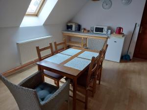 a kitchen with a wooden table and chairs in a room at Apartmán U Davida in Chvaleč +15 photos