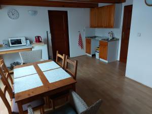 a kitchen and dining room with a table and chairs at Apartmán U Davida in Chvaleč