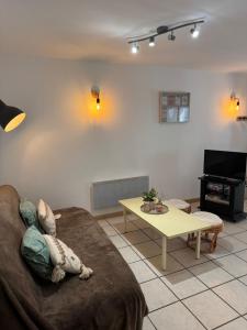 a living room with a couch and a table at Pyrenees family T3 in Aulus-les-Bains