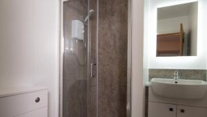 a bathroom with a shower and a sink at Ferry Inn in Stromness +76 photos