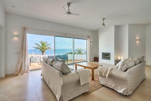 a living room with a view of the ocean at Villa Mar Gran in Cacla D'or