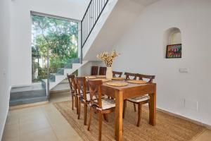 a dining room with a wooden table and chairs at Villa Mar Gran in Cacla D'or