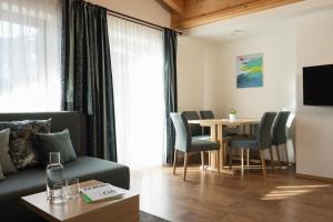 a living room with a couch and a table at Haus Kristall inkl der SUPER SOMMER CARD im SOMMER 2026 in Serfaus
