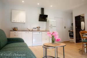 a living room with a couch and a table with flowers at Chez Agnès in Chailly-sur-Armançon +6 photos