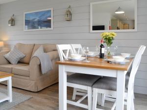 a living room with a table and a couch at Pine View Cottage in Filey