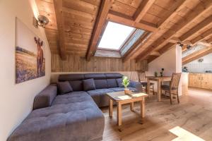 a living room with a couch and a table at Bergliebe in Schleching