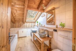 a small kitchen with a sink and a window at Bergliebe in Schleching +1 photo