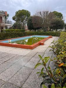 a swimming pool with a fountain in a park at Nuovo Sile in Cavallino-Treporti