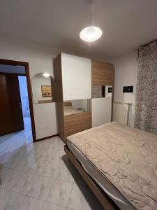 a bedroom with a large bed and a large mirror at Nuovo Sile in Cavallino-Treporti +1 photo