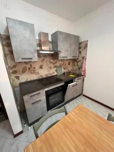 a kitchen with stainless steel appliances and a wooden table at Nuovo Sile in Cavallino-Treporti