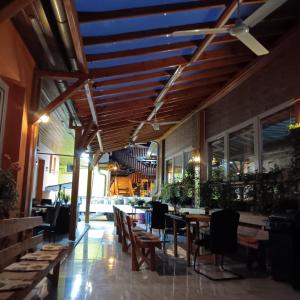 a restaurant with wooden ceilings and tables and chairs at Békési Apartmanok in Békés +58 photos