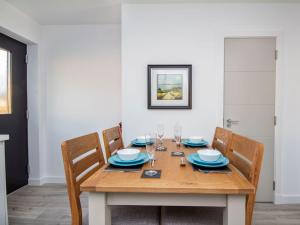 a wooden table with blue plates and glasses on it at Oakwood in Aviemore