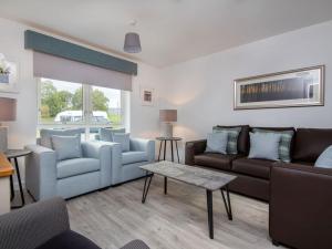 a living room with two couches and a table at Oakwood in Aviemore
