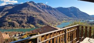 a view of a river and mountains from a balcony at La Magia del Lago in Ranzanico