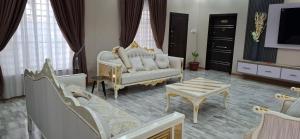 a living room with a couch and a tv at Pelican VVIP Villa in Wa