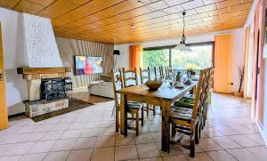 a dining room with a table and a fireplace at Haus Am Mühlenberg in Löhlbach