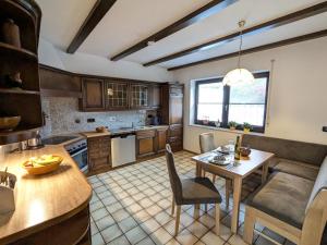 a kitchen with a table and a dining room at Haus Am Mühlenberg in Löhlbach +3 photos