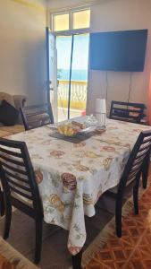 a dining room table with a plate of fruit on it at Pacific View Apartment in Roseau +46 photos