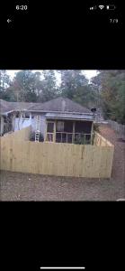 a house with a wooden fence in front of it at Alaynah's Place in Brunswick