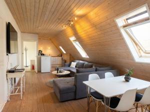 a living room with a couch and a table at Penthouse - 3BR - Esbjerg Island in Esbjerg
