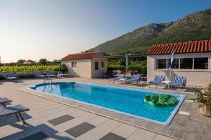 a villa with a swimming pool and a house at Villa Liberty 2 in Cavtat