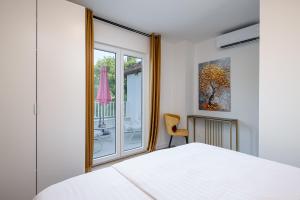 a bedroom with a white bed and a window at Villa Liberty 2 in Cavtat +49 photos