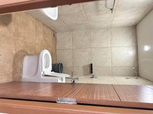 a bathroom with a white toilet in a room at KSM Rooms in Tiruvannāmalai