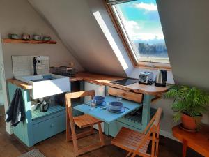 a tiny kitchen with a sink and a window at The Wee Loft in Carrbridge