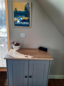 a white cabinet with a wooden counter top in a room at The Wee Loft in Carrbridge