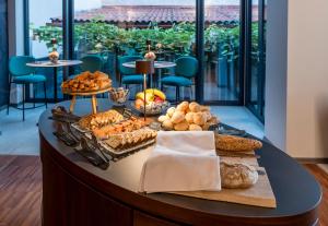 a buffet of bread and pastries on a table at Hotel Mrak in Ljubljana