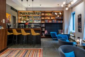 a bar in a restaurant with yellow bar stools at Hotel Mrak in Ljubljana