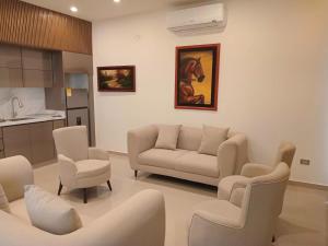 a living room with a couch and chairs at Hotel Murahno Collection in Cúcuta
