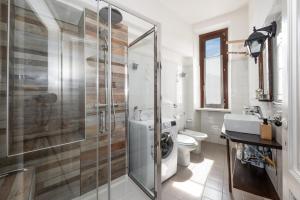 a bathroom with a shower and a toilet and a sink at Casa Clem centro Menaggio con possibilità di garage in Menaggio +13 photos