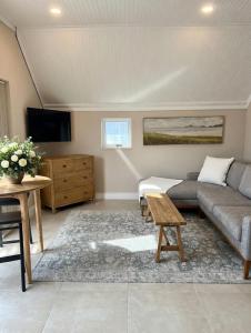 a living room with a couch and a table at Luxurious Loft on Spinnaker! in Knysna