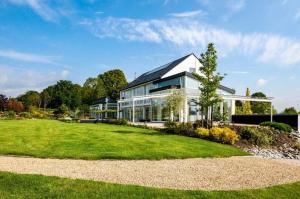 a large white house with a large yard at Villa Bianca in Dalhem
