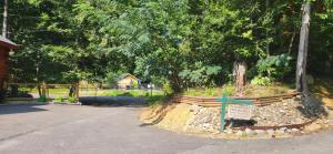 a sign in the middle of a park with trees at The Bears Den in Gatlinburg