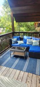 a porch with blue couches on a wooden deck at The Bears Den in Gatlinburg