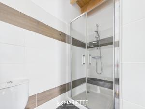 a glass shower stall in a bathroom with white walls at -LE CHALET- Joli cocon au centre de Concarneau in Concarneau +34 photos