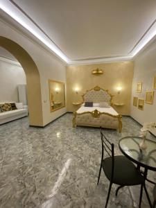 a bedroom with a bed and a table in it at Suite Incentro Salerno in Salerno +29 photos