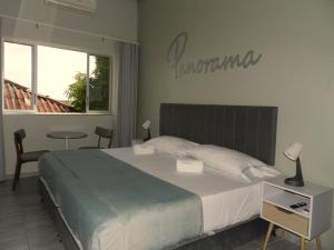 a bedroom with a large bed and a table at Panorama 1947 - Hotel Boutique Galería in El Banco