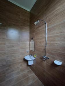 a bathroom with a sink and a shower at Karibu Haven Apartments in Arusha +45 photos