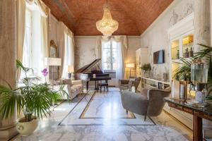 a living room filled with furniture and a chandelier at Hotel Embassy in Florence