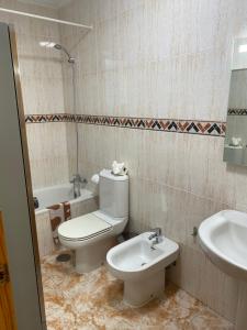 a bathroom with a toilet and a sink at Angeleyes in San Pedro del Pinatar +18 photos