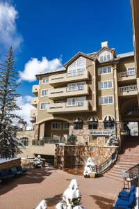 a large building with a statue in front of it at St James Beaver Creek, A Vail Resorts Property in Beaver Creek