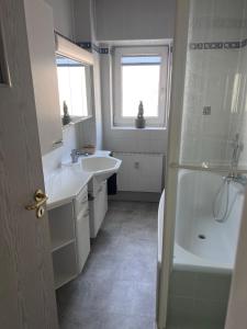 a bathroom with a shower and a sink and a tub at Gästezimmer in Hessisch Lichtenau in Lichtenau