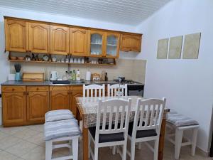 a kitchen with a table and chairs and a kitchen with a stove at Piknik Garden in Senta